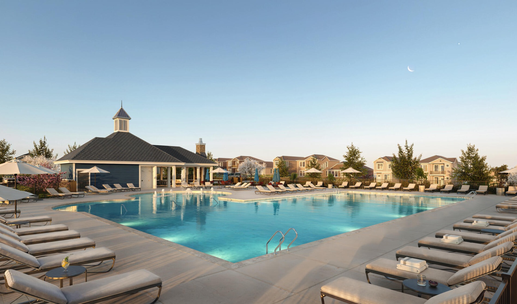 Pool at dusk with sun deck seating