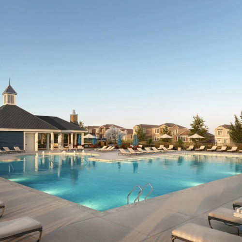 Pool at dusk with sun deck seating