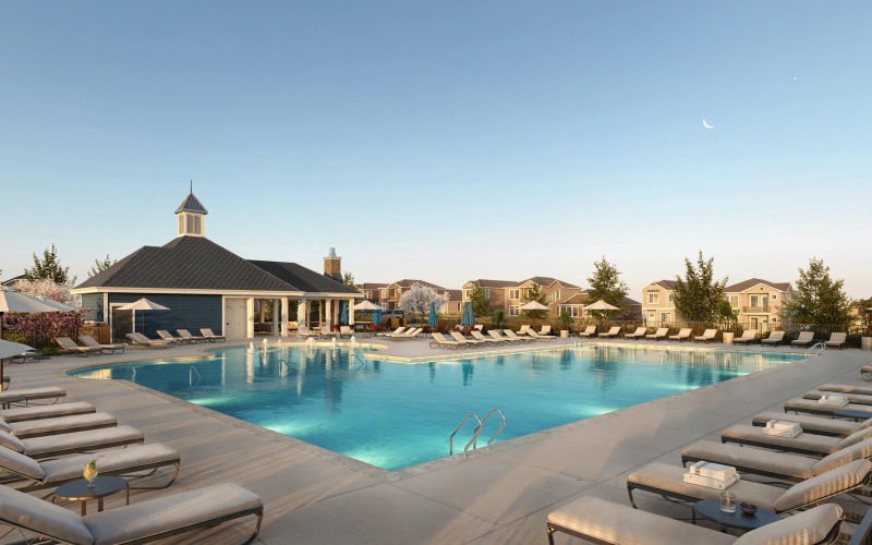 Pool at dusk with sun deck seating